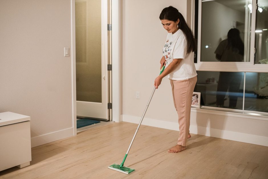 Woman mopping a clean wooden floor in a bright apartment. Photo by RDNE Stock project on Pexels