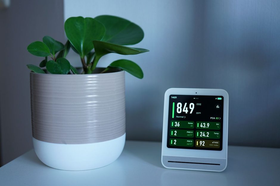 Photo by Tim Witzdam on Pexels Indoor air quality monitor showing humidity readings beside a potted plant. Photo by Tim Witzdam on Pexels