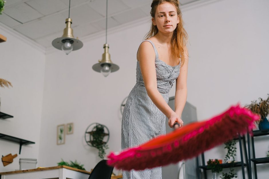 Photo by SHVETS production on Pexels Cleaner dusting a bright home interior with a red feather duster during a one-time clean. Photo by SHVETS production on Pexels