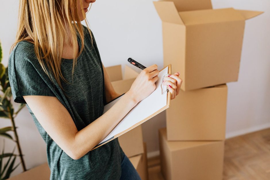 Woman with a clipboard going through a checklist inside a home. Photo by https://kaboompics.com/ on Pexels