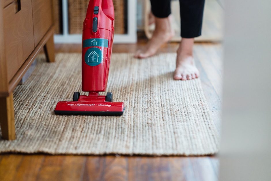 Photo by Liliana Drew on Pexels Red handheld vacuum cleaning a woven rug on a wooden floor. Photo by Liliana Drew on Pexels