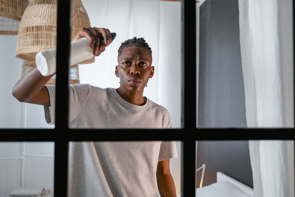 Photo by MART PRODUCTION on Pexels Man spraying and wiping a black-framed window in a bright room. Photo by MART PRODUCTION on Pexels