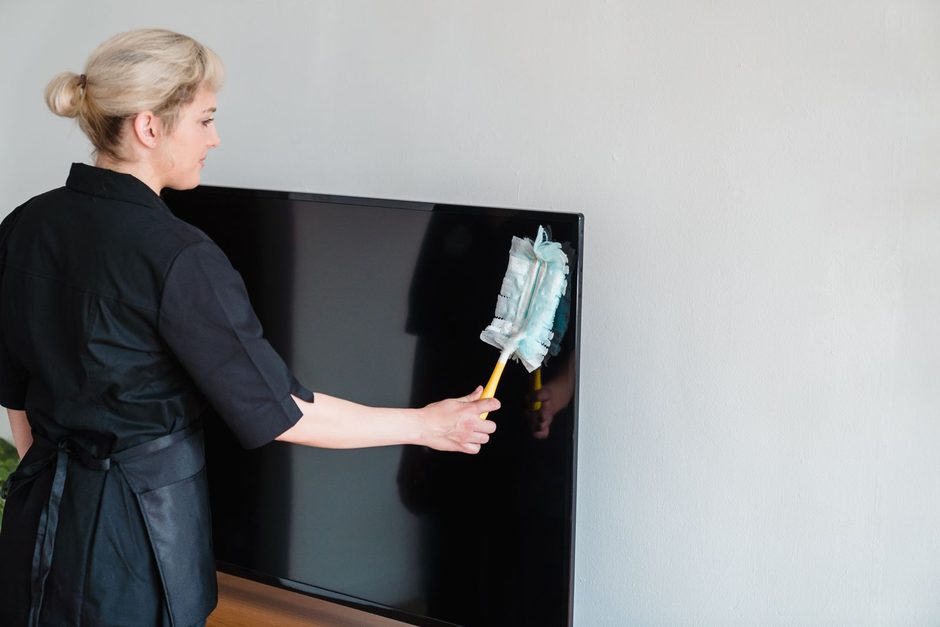 Photo by Liliana Drew on Pexels Woman in black dusting a wall-mounted panel with a duster in a white room. Photo by Liliana Drew on Pexels